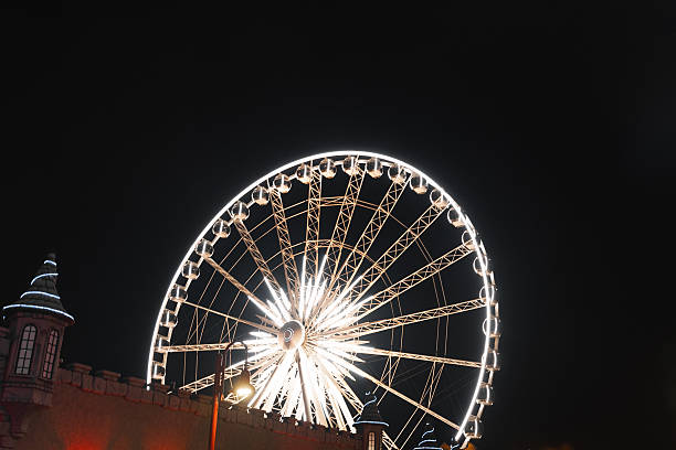 Ferris Wheel (Budapest Eye) illuminated at dusk in city center. Photo taken at cloudy day. City center, Budapest, Hungary