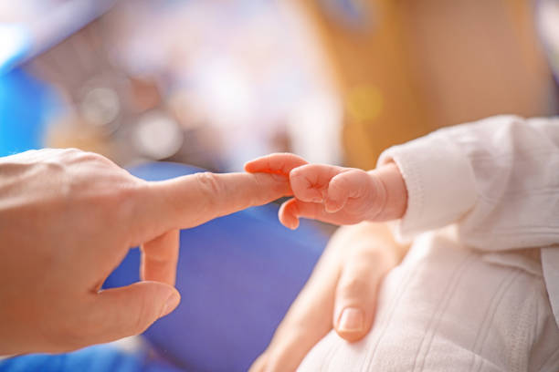 heartwarming moment capturing a baby's hand grasping their mother's finger, symbolizing love, connection, and the bond between parent and child