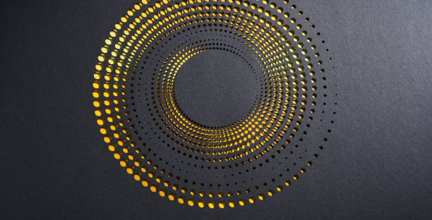 Intricate circular cut-paper artwork with layered perforations on a black background and golden light accents