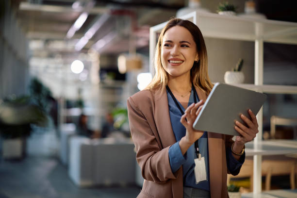 istock Happy businesswoman using touchpad while working in the office. 2199415553