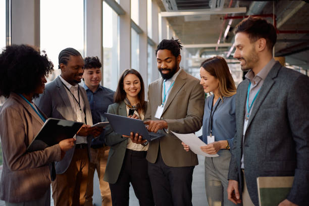 istock Black businessman using laptop while leading a business meeting in the office. 2199415592