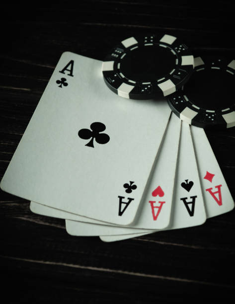 istock In a cozy gambling atmosphere, four aces elegantly fan out beside a stack of black and white poker chips. The warm glow creates an air of anticipation and excitement during a thrilling game night 2199415821