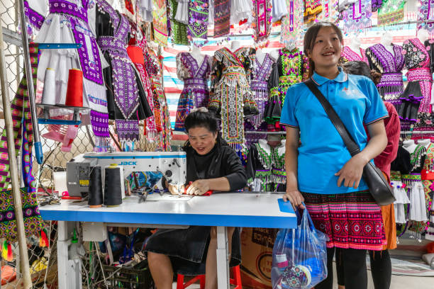 Sapa, Vietnam - March 24, 2024: A Vietnamese woman sews Vietnamese folk costumes