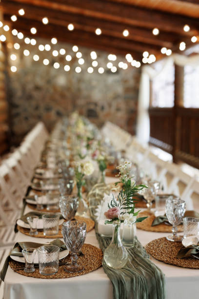 istock Elegant banquet table settings with white tablecloths and native Australian floral arrangements in an event hall. 2199421187