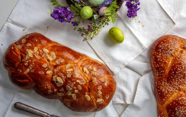 istock Easter sweet bread, tsoureki braid and colorful Easter eggs on the table 2199422410