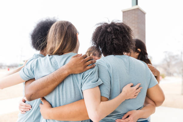 istock Group of diverse women embracing in support and togetherness 2199422982
