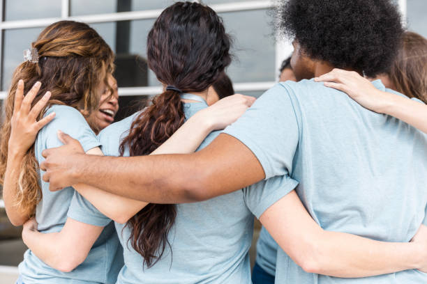 istock Group of diverse women embracing, showing togetherness and support 2199423249