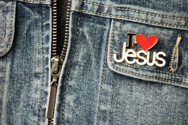 Pocket detail of denim jacket with I Love Jesus brooch