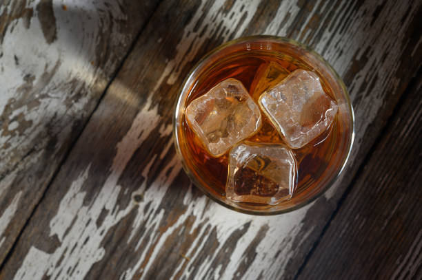 istock Refreshing drink with ice cubes on rustic wooden table during a warm evening gathering 2199425045