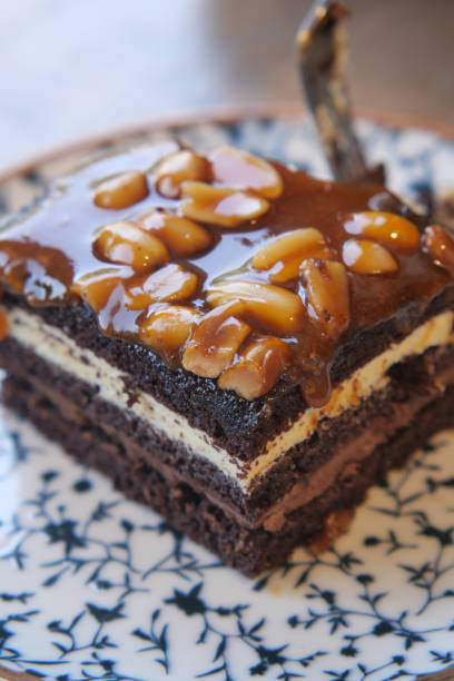 istock Indulgent and Decadent Chocolate Cake Topped Richly with a Delicious Nut Topping 2199429389