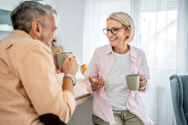 istock Mature couple chatting and drinking coffee in the morning 2199429808