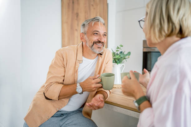 istock Mature couple chatting and drinking coffee in the morning 2199429849