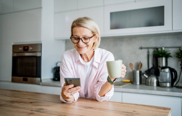 istock Woman drinking coffee and using phone 2199430127
