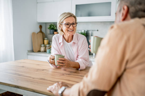 istock Mature couple drinking coffee together in the kitchen 2199430742