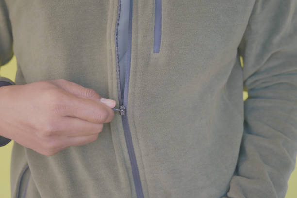 istock Man zipper on a jacket in cold autumn day. 2199430952