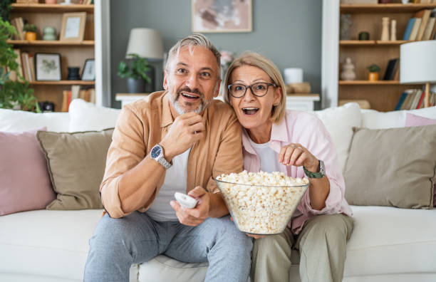 istock Mature couple watching tv at home 2199431077