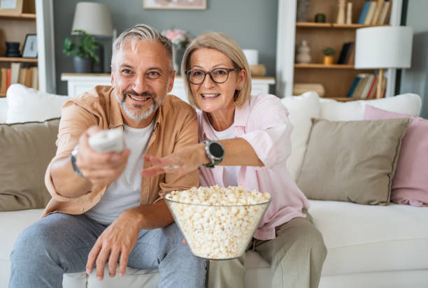 istock Mature couple watching tv at home 2199431282