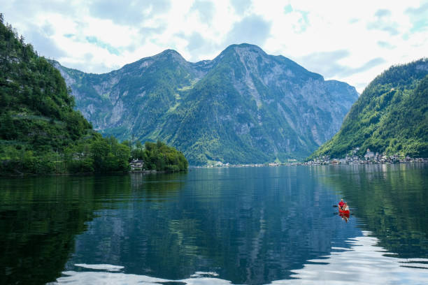 istock Tranquil Lake with Kayakers and Majestic Mountains 2199434245