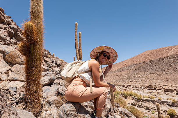 istock Young woman hiking in desert landscape with cactus 2199435932