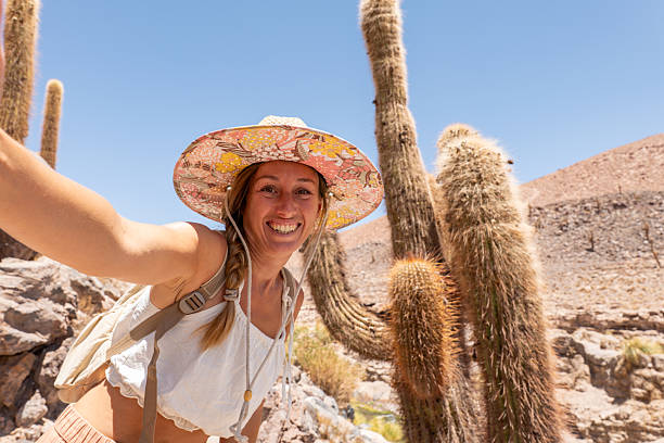istock Woman Taking Selfie in Desert with Tall Cacti 2199436239
