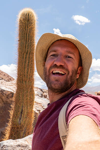 istock Smiling Man Taking Selfie on Rocky Desert Trail 2199436962
