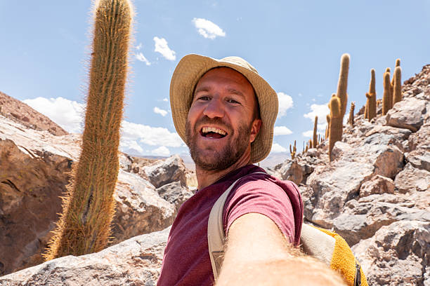 istock Smiling Man Taking Selfie on Rocky Desert Trail 2199437004