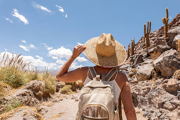 istock Woman Hiking in Desert Landscape with Backpack 2199437025