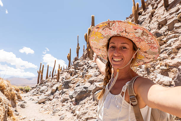 istock Smiling Woman Taking Selfie on Desert Hiking Trail 2199437125