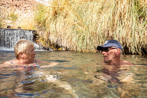 istock Couple Relaxing in Natural Hot Spring 2199439408