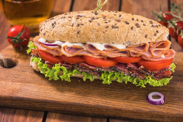 Fresh homemade submarine sandwich with salami, ham, tomato and lettuce