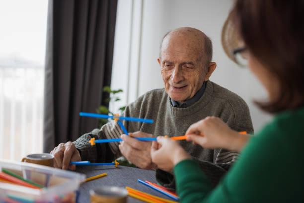 istock Senior man playing with straw flexible block game set 2199450055