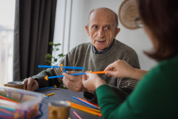 istock Senior man playing with straw flexible block game set 2199450143