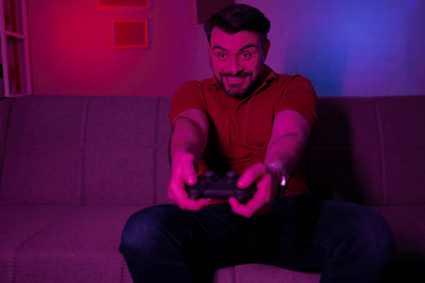 istock Mid Adult Man Enthusiastically Playing Video Games 2199450319