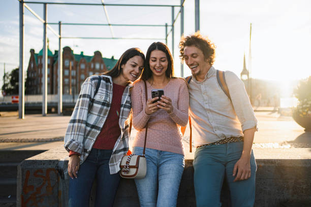 istock Young tourists using smartphone in Copenhagen at sunset 2199451281