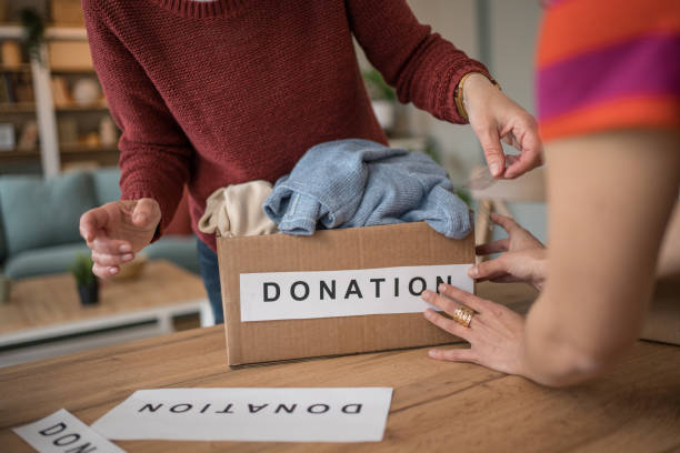 istock Women organizing clothes donation at home 2199452237