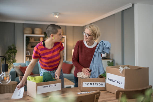 istock Women organizing clothes donation at home 2199452267