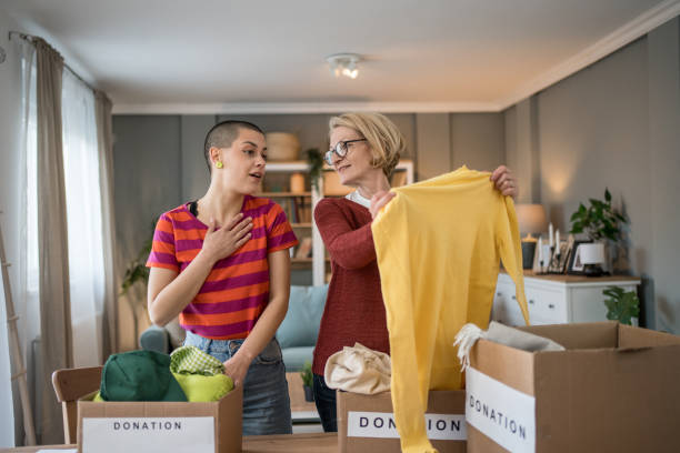 istock Women organizing clothes donation at home 2199452277