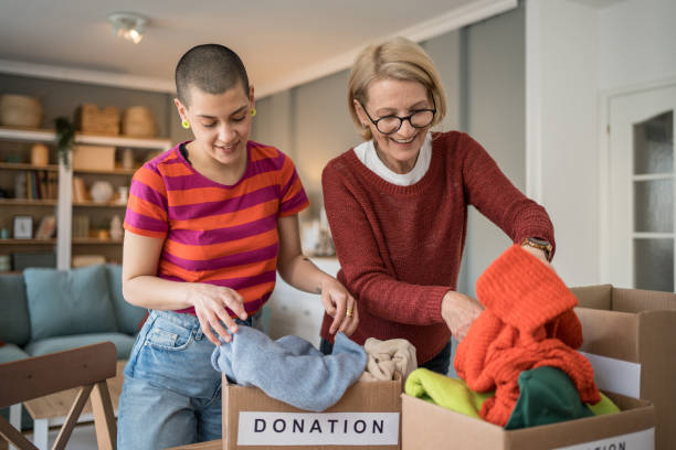 istock Women organizing clothes donation at home 2199452286