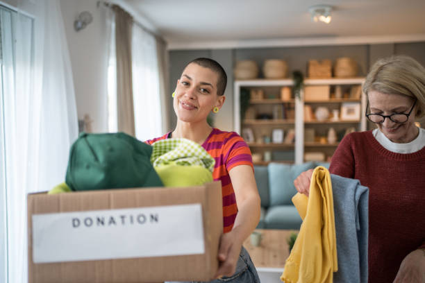 istock Women organizing clothes donation at home 2199452296