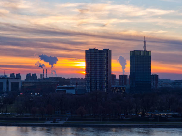 istock Sunset cityscape with skyscrapers and industrial emissions 2199456466