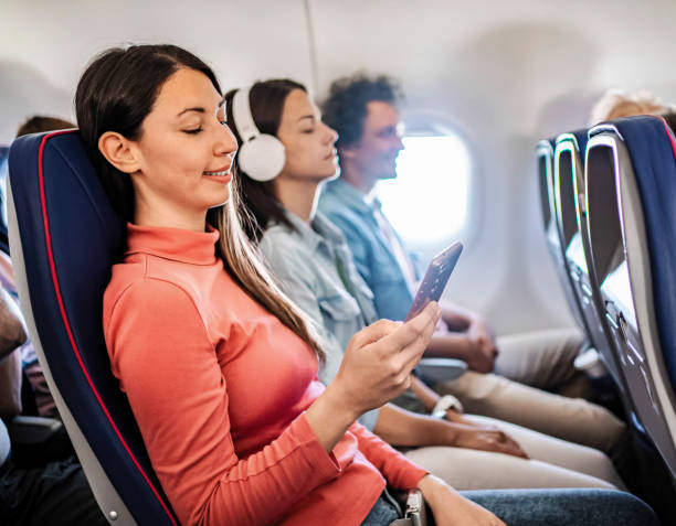 istock Young woman using phone during flight to Malmo, Sweden 2199456483