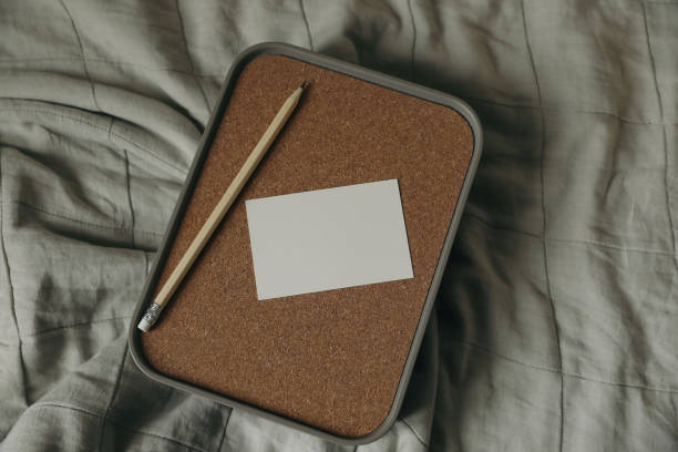 istock Empty business card, invitation mockup, wooden pencil on storage container box, cork lid. Wrinkled beige cloth, throw. Elegant branding template. Flat lay, top view. Copy space. Moody still life. 2199459745