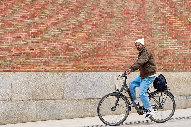 istock Stylish man riding a bicycle in the city 2199461233