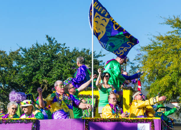 Mobile, Alabama, USA - March 2, 2014: Mardi Gras revelers throw trinkets to the crowd during the Joe Cain Day parade in Mobile, Alabama.