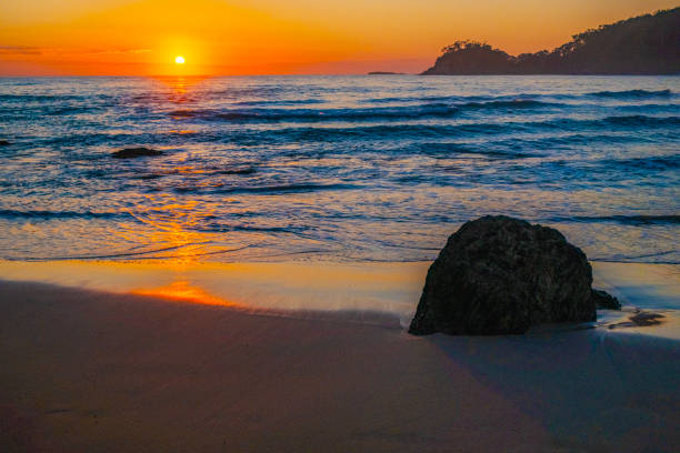 what a wonderful morning? sun just breaking over the ocean at Surf beach on the south coast of NSW. Australia.