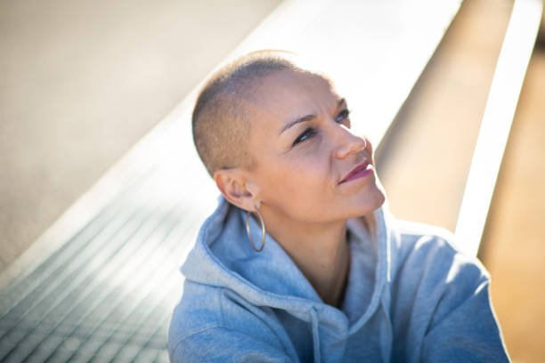 istock Close up beautiful woman with shaved head 2199471888