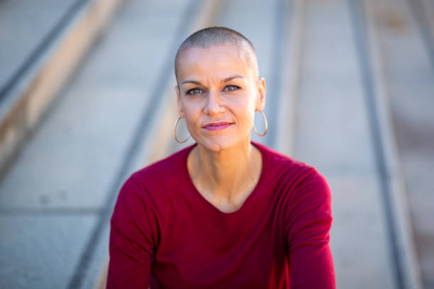 istock Close up older woman with shaved head 2199471993
