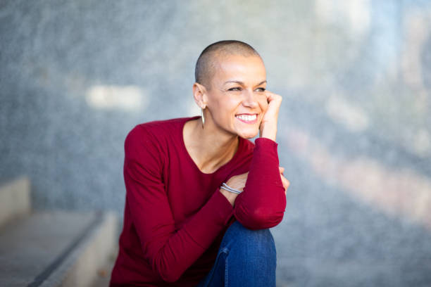 istock beautiful woman with shaved head smiling 2199472032