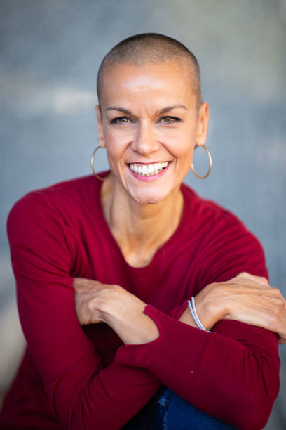 istock Close up smiling woman with shaved head 2199472038