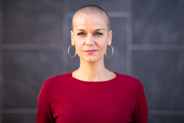 istock serious woman with shaved head 2199472042